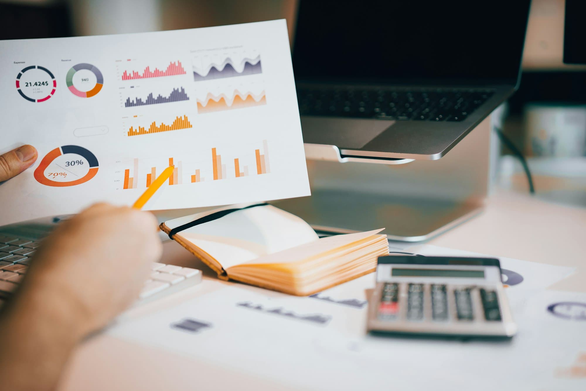Printed charts and a calculator used to review outstanding balances