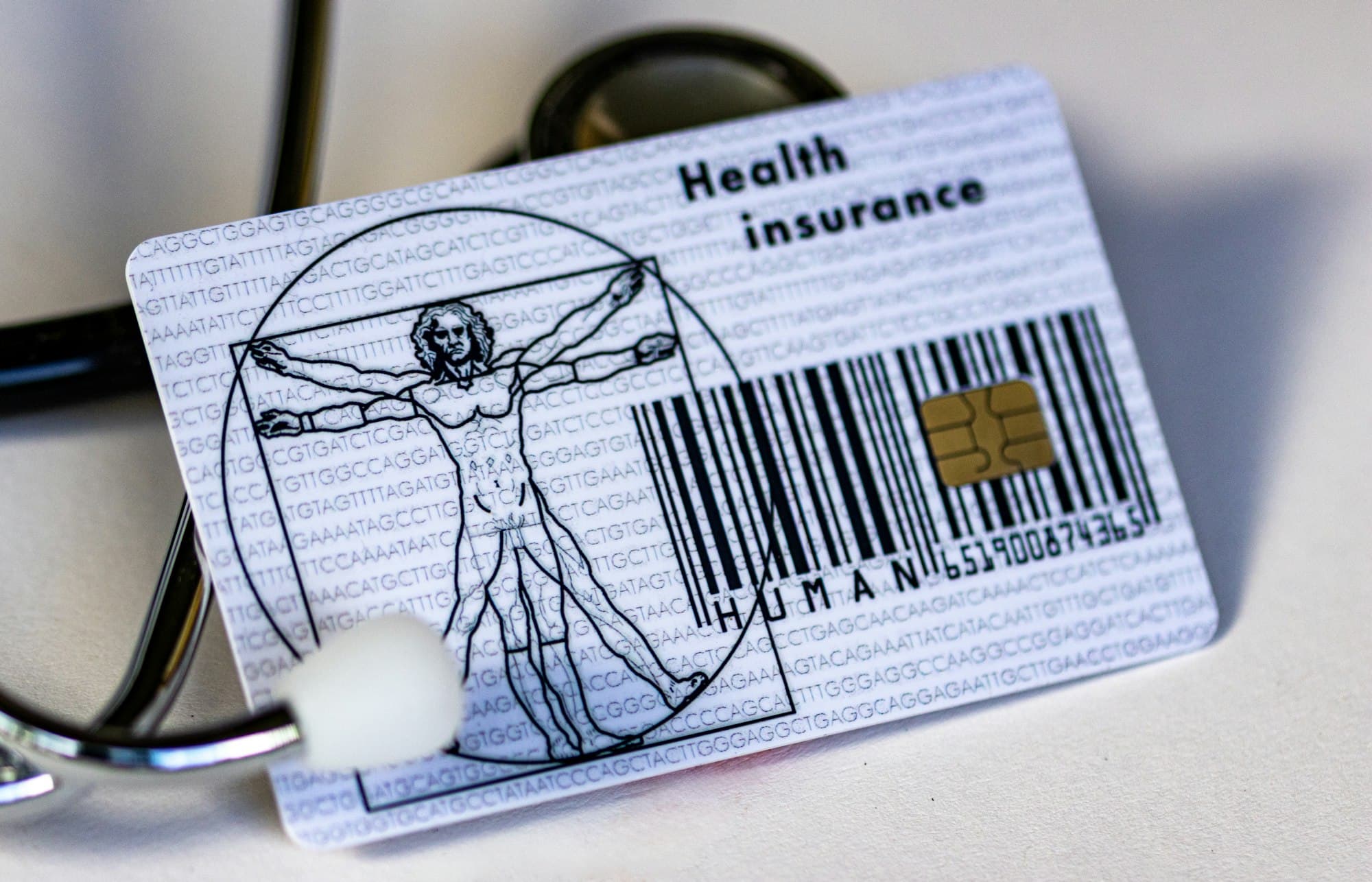 A health insurance card resting beside a stethoscope